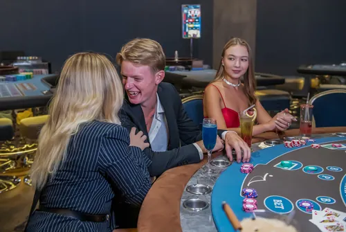 Two guests celebrating a win at the table
